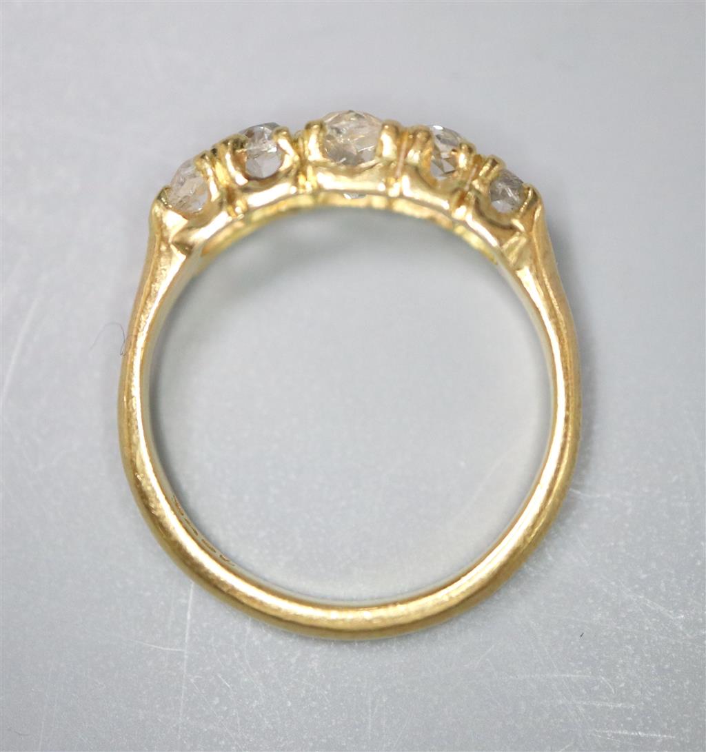 An 18ct and graduated five stone old cut diamond set childs ring, size E/F, gross 2.5 grams.